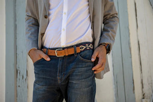 The LA MATERA - PALOMA WOVEN BELT features brown genuine leather, a silver buckle, and navy Argentine fabric with a beige geometric pattern—a stylish accessory for any outfit from LA MATERA.