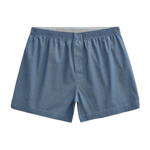 A person is shown from the waist down, wearing MACK WELDON 24/7 Woven Boxer in True Navy Dobby Dot. The background is plain and light gray.
