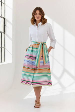 A woman wears the HINSON WU Robin 3/4 Sleeve Linen Dress in Multi Stripe, featuring breathable fabric and a matching tie belt, standing against a plain light background.