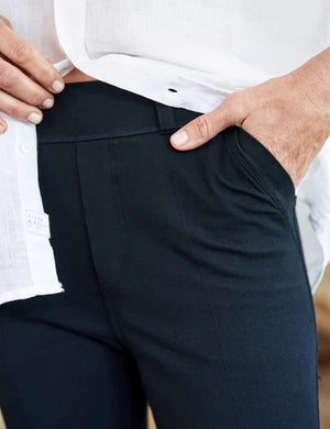 The FRANK & EILEEN Murphy Billion Dollar Pant in black, featuring a tailored waistband and side pockets, is displayed flat on a white textured background.