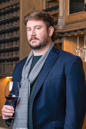 Enjoy a Dynamis Wine Dinner by FEARRINGTON VILLAGE, inspired by the lush Dynamis Estate in North Carolina’s Swan Creek—vineyards nestled among rolling hills and dense forests, with grapevines lining the landscape under bright blue skies.