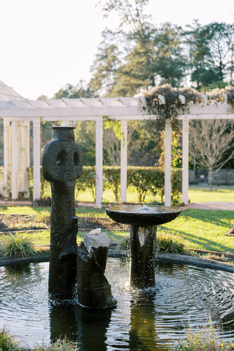 Fountain with stone sculpture in a garden setting