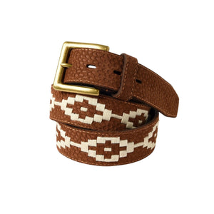 The LA MATERA - EL CAMPO POLO BELT by LA MATERA features brown saddle leather, a gold buckle, textured surface, and white hand-embroidered geometric patterns, coiled neatly against a white background.