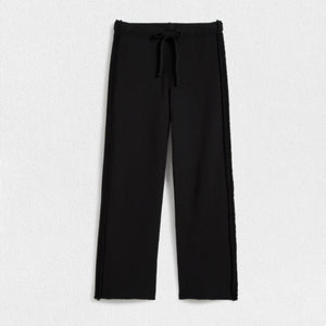 The FRANK & EILEEN BELLA Italian Sweatpant in black features a drawstring waist, side seam detail, and a lightly frayed hem, shown flat on a light textured background.