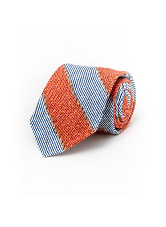 The EDWARD ARMRAH - ORANGE FANCY SILK TIE by EDWARD ARMAH features bold orange textured stripes with slim blue and white pinstripes, rolled and displayed on a plain white background.