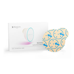 A person with short brown hair and multiple ear piercings uses the OMNILUX round skincare device emitting red light on their forehead, which is covered by an OMNILUX - BLEMISH ERASER HYDROCOLLOID PATCH REFILL KIT patch.