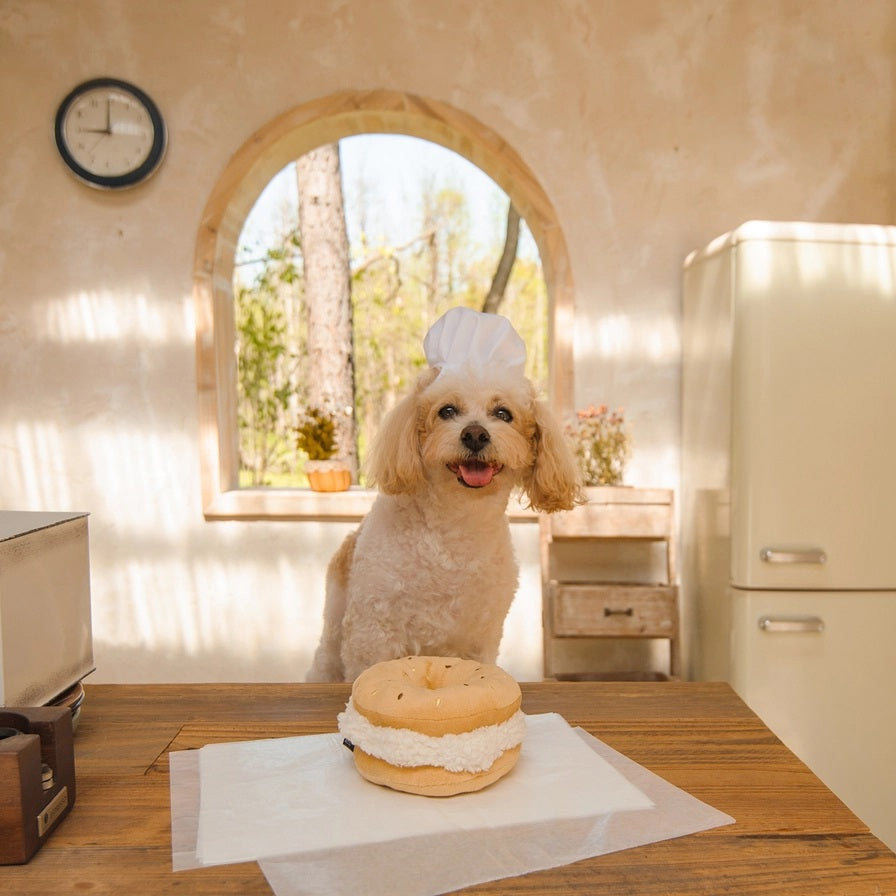 The CHEWFFON BAGEL PLUSH SQUEAKY DOG TOY is an adorable interactive plush shaped like a bagel sandwich filled with cream cheese and topped with colorful sprinkles to resemble real bagel toppings—perfect for playful pups who love a squeaky challenge!.