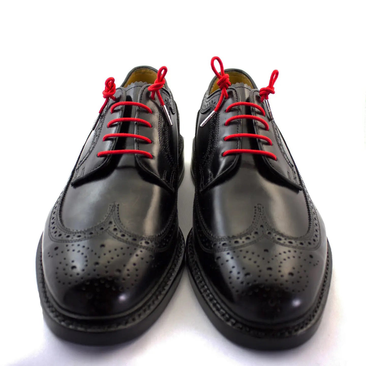 A pair of STOLEN RICHES Dress Shoelaces in Portsalon Red, neatly bundled with a white paper band featuring a crown logo and “STOLEN RICHES” in black.