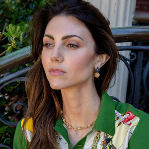 The CAPUCINE DE WULF Berry Clover Drot Earrings with Labradorite feature an 18K gold-plated design, showcasing a cluster of small gold beads as the main drop and a stud top accented with four oval blue stones arranged in a delicate floral pattern—handmade jewelry offering a timeless elegance by CAPUCINE DE WULF.
