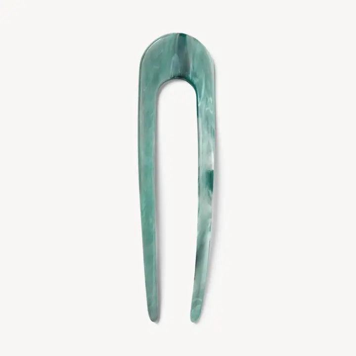 A smooth, black MACHETE - FRENCH HAIR PIN with two prongs, crafted from Italian acetate by MACHETE, rests on a plain white surface.