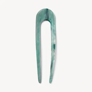 A smooth, black MACHETE - FRENCH HAIR PIN with two prongs, crafted from Italian acetate by MACHETE, rests on a plain white surface.