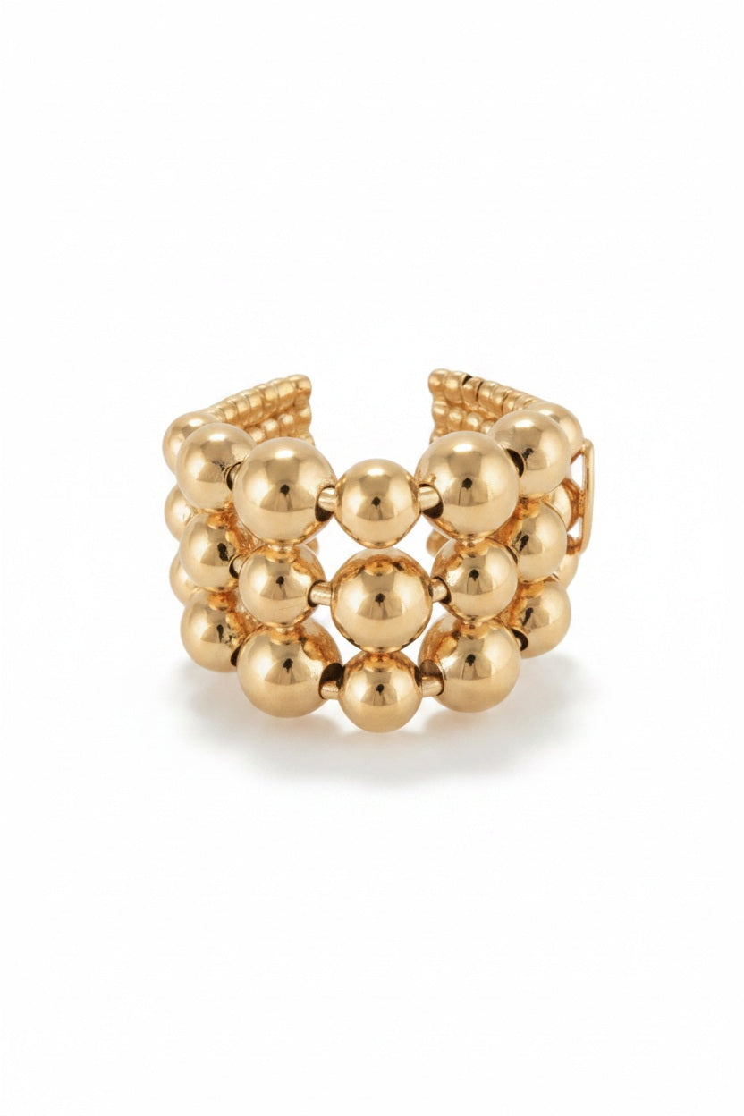 The GAS BIJOUX - MUTIPERLA RING features three rows of polished, gold-plated beads in an adjustable, open-back design by GAS BIJOUX, displayed against a white background.