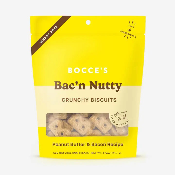 A yellow and cream BOCCE'S BAKERY BAC N NUTTY BISCUITS bag features wheat-free, bone-shaped dog treats made with peanut butter and bacon.