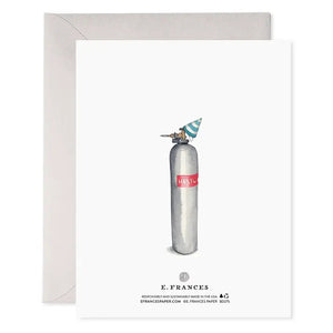 The E. FRANCES PAPER Helium 50 Birthday Card features silver balloon numbers "50" and the phrase "Cheers to a phenomenal new decade!" in gold, making it the perfect festive balloon birthday card. A light grey envelope is positioned behind the card, set against a clean white background.