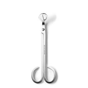 A pair of sleek, chrome-plated wick trimmers with a long handle and scissor-like blades. The MOLTON BROWN - WICK TRIMMER features rounded finger loops and engraved text that reads "MOLTON BROWN" against a white background, perfect for maintaining your scented candles.
