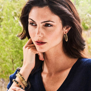 CAPUCINE DE WULF - BERRY ICON MEDIUM HOOP EARRINGS: Handmade 18K gold hoops featuring intricate beaded clusters, displayed from side and angled views against a white background.