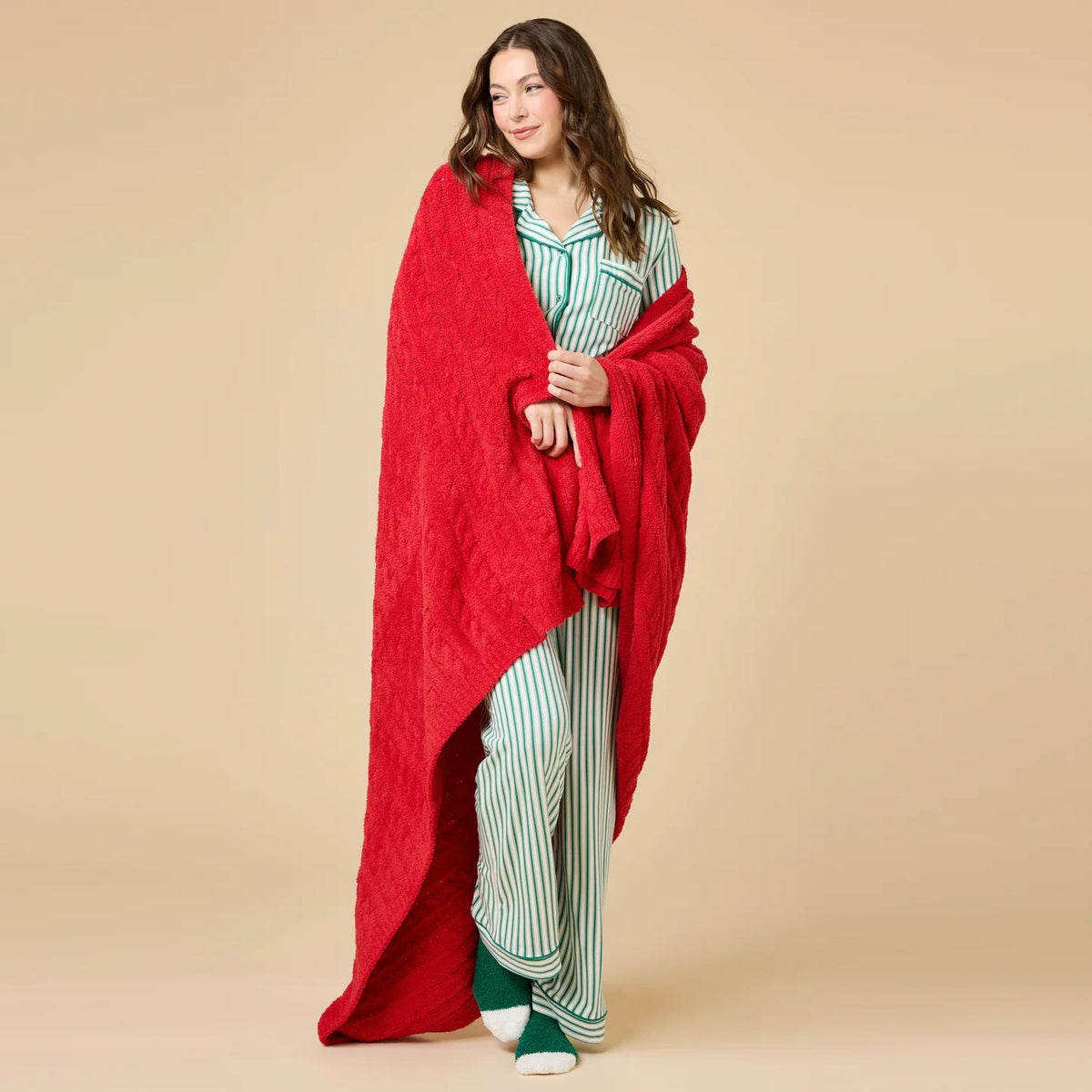 A woman wears the SOFTIES ARIA SLIM NOTCH COLLAR PJ SET, featuring a long-sleeved button-down top and matching wide-leg pants in red and white vertical stripes with red piping details.