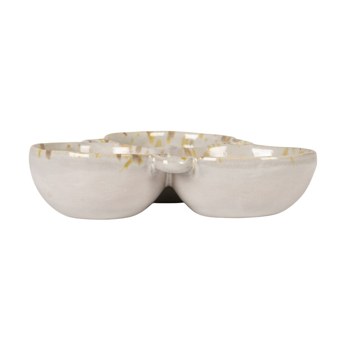 A rustic flat lay features the CREATIVE COOP 3-SECTION STONEWARE BOWL IN CREAM AND GREEN filled with spices, dried artichoke, garlic bulbs, vintage metal spoons, and assorted nuts on a textured beige surface.