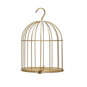 The METAL BIRD CAGE ORN by CREATIVE COOP features a golden finish with vertical bars and a domed top. Designed with a hook for hanging and a small latch-door at the bottom front, this elegant ornament stands gracefully on its base against a plain white backdrop.