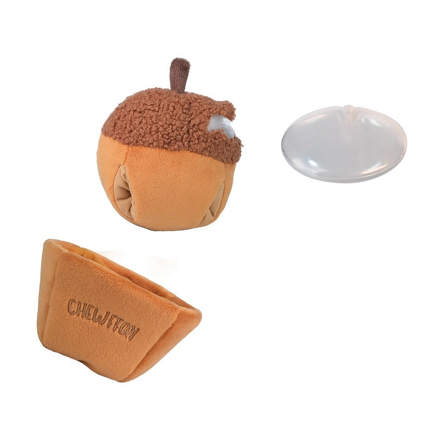 A plush, squeaky dog toy from CHEWFFON shaped like an acorn, featuring a textured brown top and a smooth tan base. The word “CHEWFFON” is embroidered on the base in light brown thread. This toy is called the ACORN SNUFFLE &amp; SQUEAKY DOG TOY.