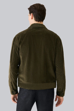 The MACK WELDON - CORDUROY ZIP JACKET is a modern-fit, dark blue corduroy jacket with a front zipper, long sleeves, collar, and chest pocket—shown against a white background.