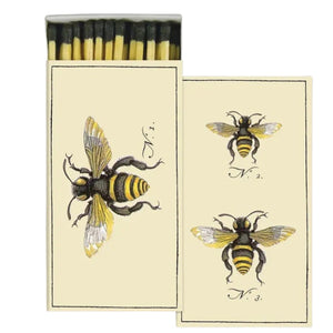 The HOMART MATCHES - BEES box contains yellow-tipped safety matches and features a vintage bee illustration on the box, with three labeled bees on an enclosed card—making it a delightful and charming hostess gift.