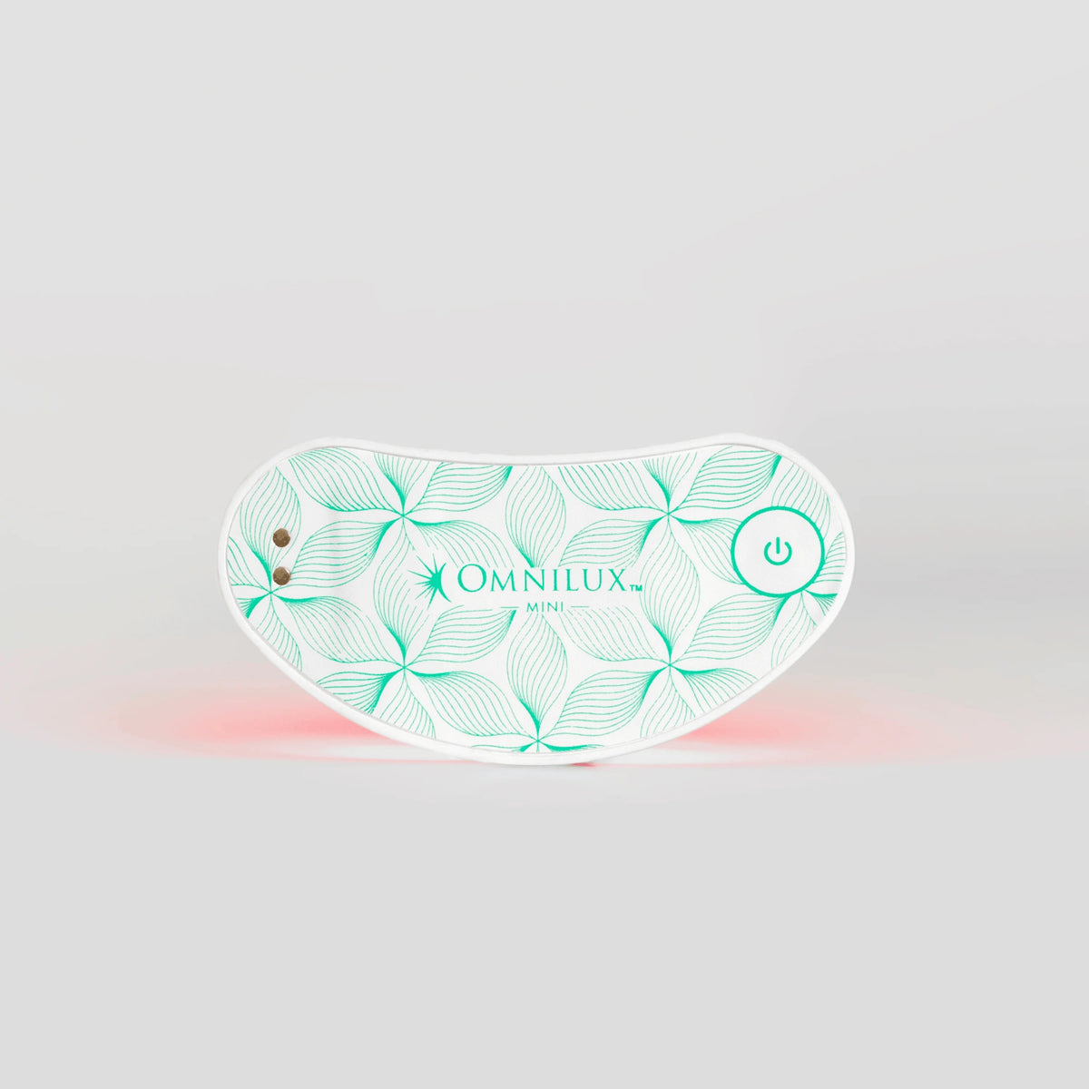 An individual relaxes with closed eyes, using the OMNILUX EYE BRIGHTNER KIT. The compact, curved device fits effortlessly under the eye, emitting red light therapy to target eye bags and enhance collagen production for a contented experience.