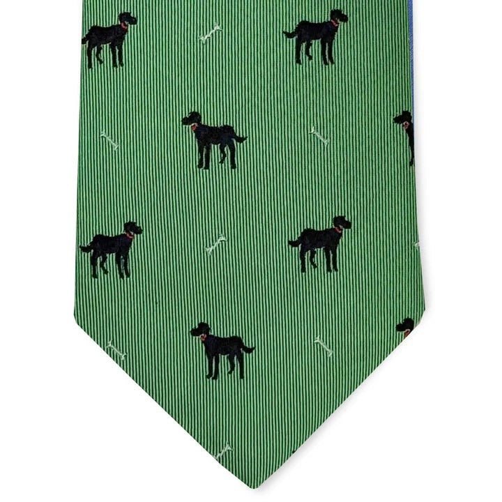 A rolled-up BIRD DOG BAY Black Lab Silk Tie in Mint, featuring a pattern of small black dogs and white bones evenly spaced across the woven silk, crafted in the signature style of BIRD DOG BAY.