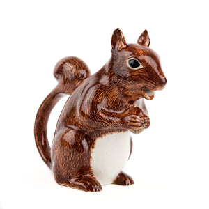 The QUAIL CERAMICS - SQUIRREL JUG by QUAIL DESIGNS is a hand-painted stoneware figurine depicting a brown squirrel with a white belly, standing upright and holding its paws together against a plain white background.