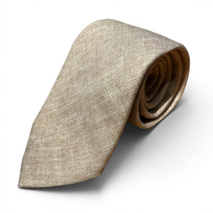 The EDWARD ARMAH Solid Khaki Silk Tie, featuring a textured finish, is shown neatly rolled on a plain white background.