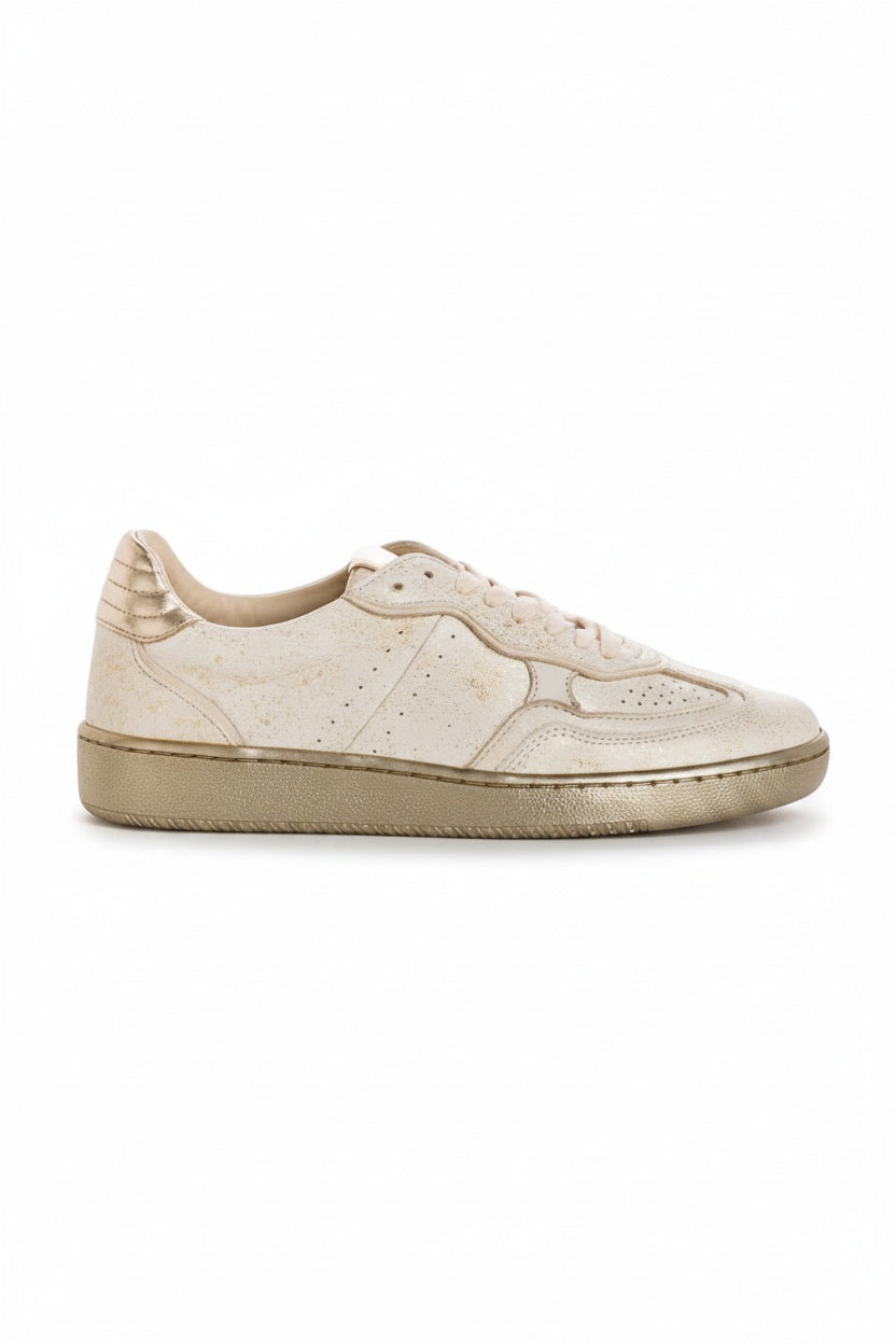 The REQINS ATHENA GLAM sneaker in platinum off white features suede leather, a textured sole, and stitched details, displayed from the side against a plain light background.