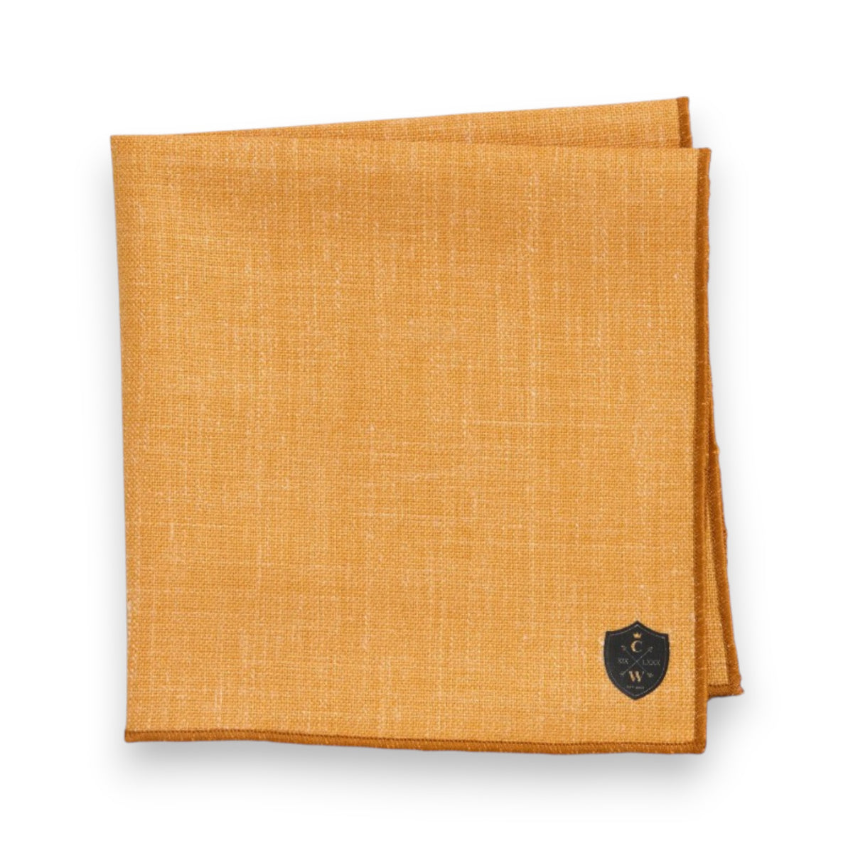 The CLIFTON WILSON Linen Pocket Square in mustard yellow, with a small black crest logo in the bottom right corner, is neatly folded and displayed on a white background.