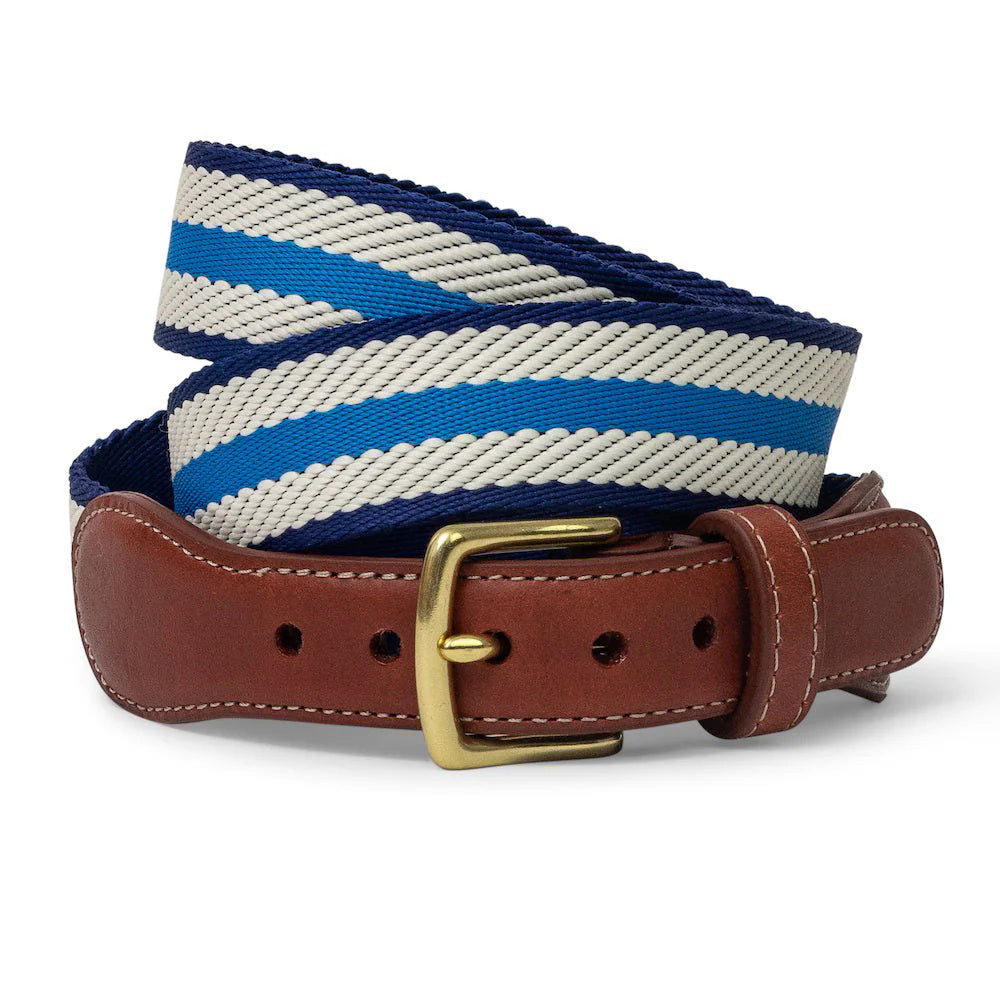 The COLLARED GREENS - DOCKSIDE BELT IN BLUE/IVORY/NAVY by BIRD DOG BAY features blue and white striped woven fabric, a gold buckle, and leather accents. Proudly made in the USA.