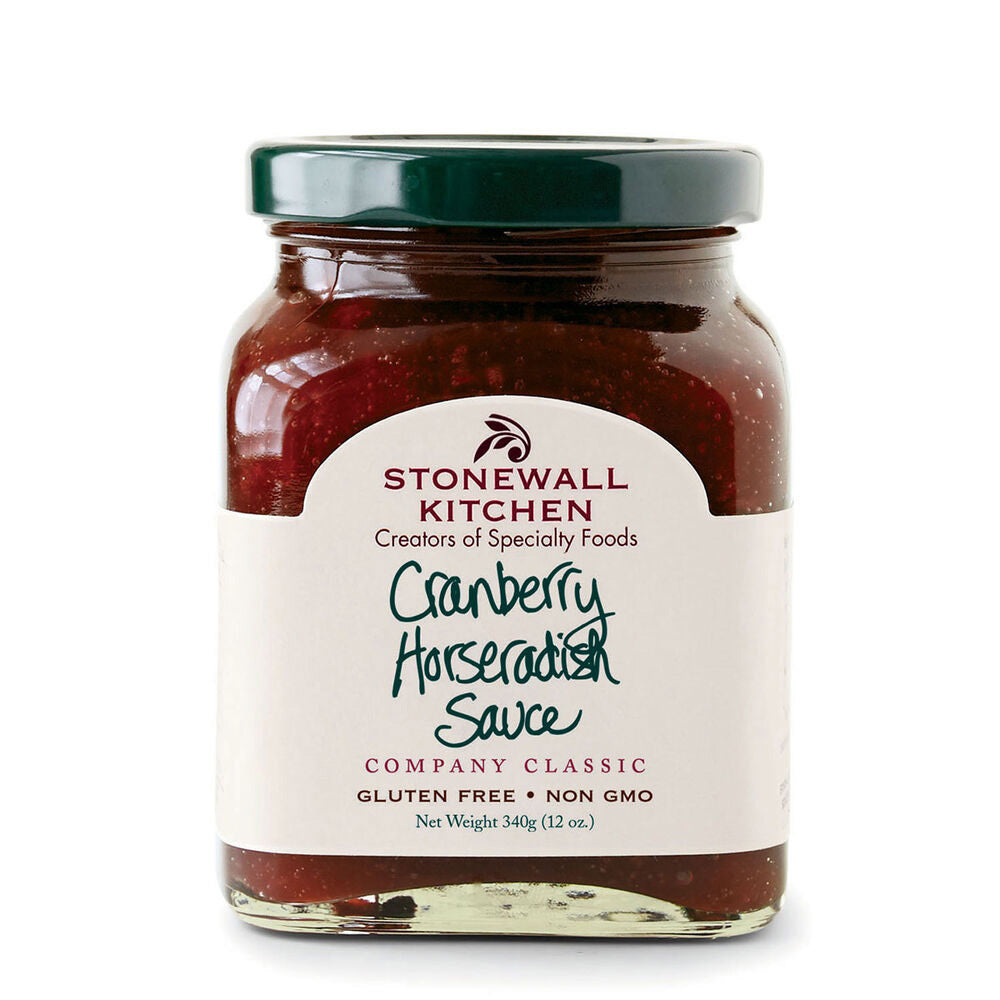 A jar of STONEWALL KITCHEN - CRANBERRY HORSERADISH SAUCE has a dark green lid and features a label that reads "Creators of Specialty Foods." It is gluten-free, non-GMO, and has a net weight of 340g (12oz). This tart and spicy reddish sauce pairs perfectly with smoked meats.