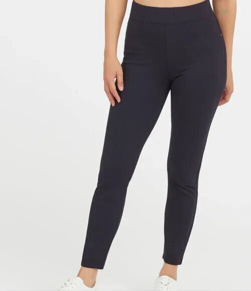 The SPANX Perfect Pant Ankle 4 Pocket leggings in black are showcased on a white background. These women&#39;s leggings, made from smoothing ponte fabric, feature a high waistband and a sleek ankle backseam skinny silhouette with a convenient pull-on design for effortless style.