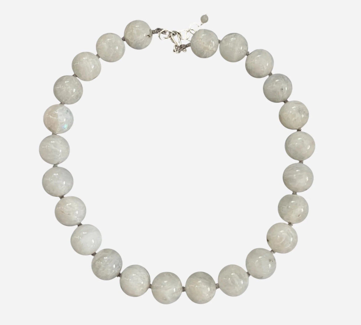 The ANN LIGHTFOOT - WHITE MOONSTONE RAS DU COU NECKLACE features smooth, large white moonstone beads and a sterling silver clasp, arranged in a circle on a white background.
