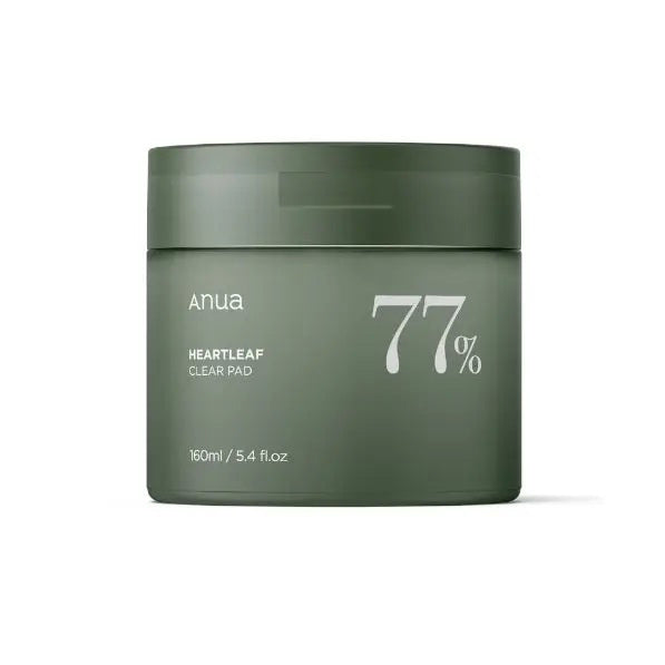 A green cylindrical container with a lid, labeled &quot;ANUA HEARTLEAF 77% CLEAR PAD&quot; in white text is featured. From KOSMIC KBEAUTY SKINCARE, it contains 160ml of heartleaf extract, renowned for anti-inflammatory benefits and minimizing pore size. Set against a plain white background.