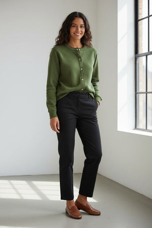 Fearrington Village model wearing a green Frank and Eileen Jackie sweatshirt cardigan with raw edges and buttons.