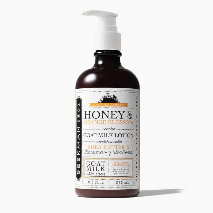 A 12.5 fl oz pump bottle of Beekman - Honey and Orange Hand Lotion from Beekman - STA Elements against a white background. The label details that this non-greasy, citrusy lotion is enriched with shea butter and rosemary verbena, offering optimal hydration for goat milk skincare.
