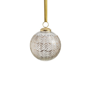 The ZODAX GOLDEN ECHOES ORNAMENT 4" is a clear glass Christmas ornament featuring a gold geometric leaf pattern, measuring 4 inches in diameter and hanging from a gold ribbon against a white background.