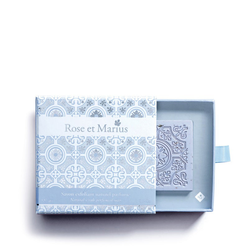 An open ROSE ET MARIUS - LAVENDER SCENTED SOLID SOAP GIFT BOX reveals a matching decorative soap, both adorned with elegant, light blue and white Provence-inspired motifs.