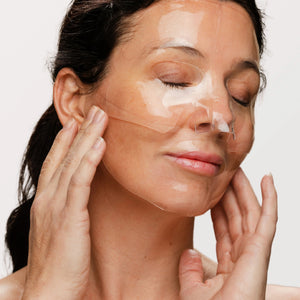 A packet from the OMNILUX - HYDROGEL FACIAL MASKS, 3 PACK, by OMNILUX, appears in white with blue accents and a gold logo, displaying English and French text on the front. The packaging highlights its infusion with Hyaluronic Acid and is centered against a plain white background.