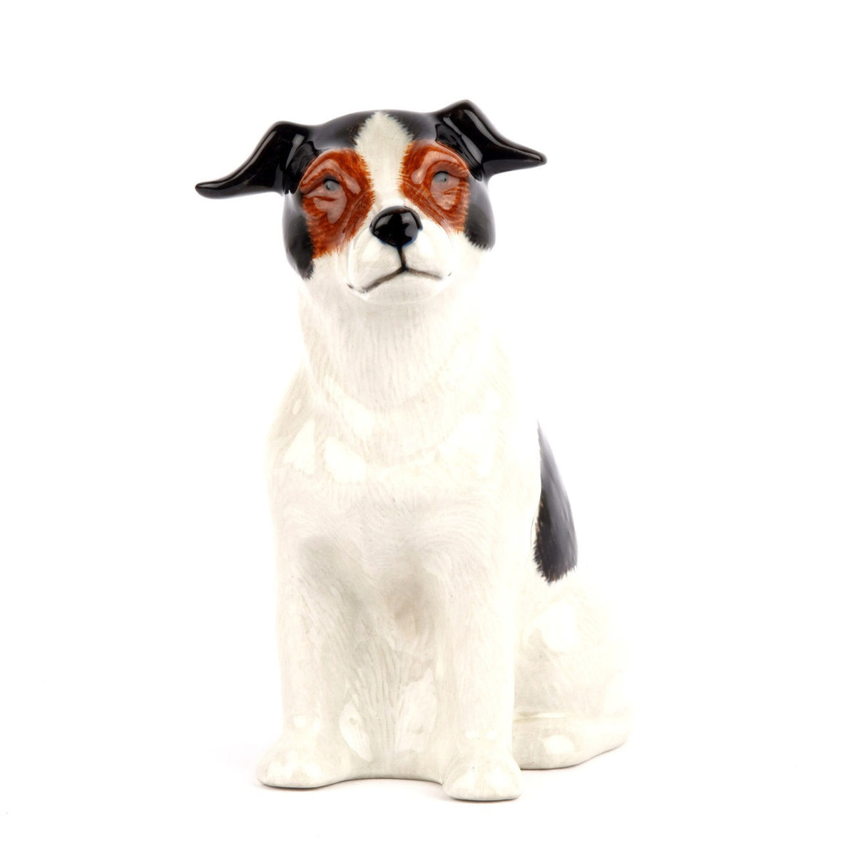The QUAIL CERAMICS - JACK RUSSELL FLOWER VASE SMALL by QUAIL DESIGNS is a hand-painted stoneware figurine of a black and white dog with brown facial details, sitting and facing right.