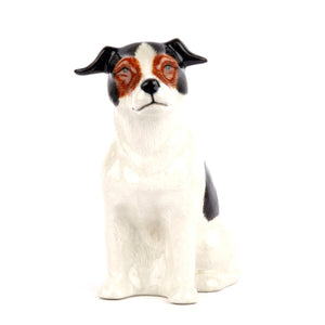 The QUAIL CERAMICS - JACK RUSSELL FLOWER VASE SMALL by QUAIL DESIGNS is a hand-painted stoneware figurine of a black and white dog with brown facial details, sitting and facing right.