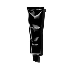 A black tube of JACK HENRY - SUPER FACE CREAM, branded with "JACK HENRY" in white text and topped with a black cap, rests on a white background casting a right-side shadow—a minimalist moisturizer ideal for anti-aging skincare.