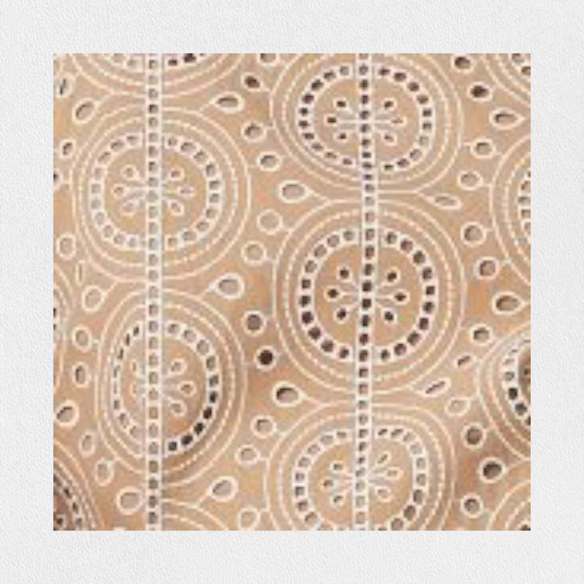 A person stands against a plain background wearing the SFIZIO - BRODERIE ANGLAISE MIDI DRESS by SFIZIO, which features elbow-length puffed sleeves and a midi-length skirt adorned with intricate lace patterns. They are also wearing black ankle-strap sandals.