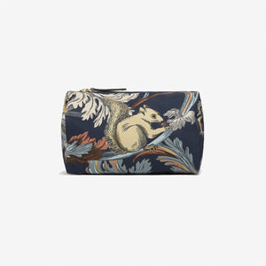 The INOUI EDITIONS ROCOCO SQUIRREL NYLON CASE SMALL by INOUI is a navy zippered pouch made from recycled polyester, featuring a gold, blue, and brown foliage design with a squirrel holding an acorn.
