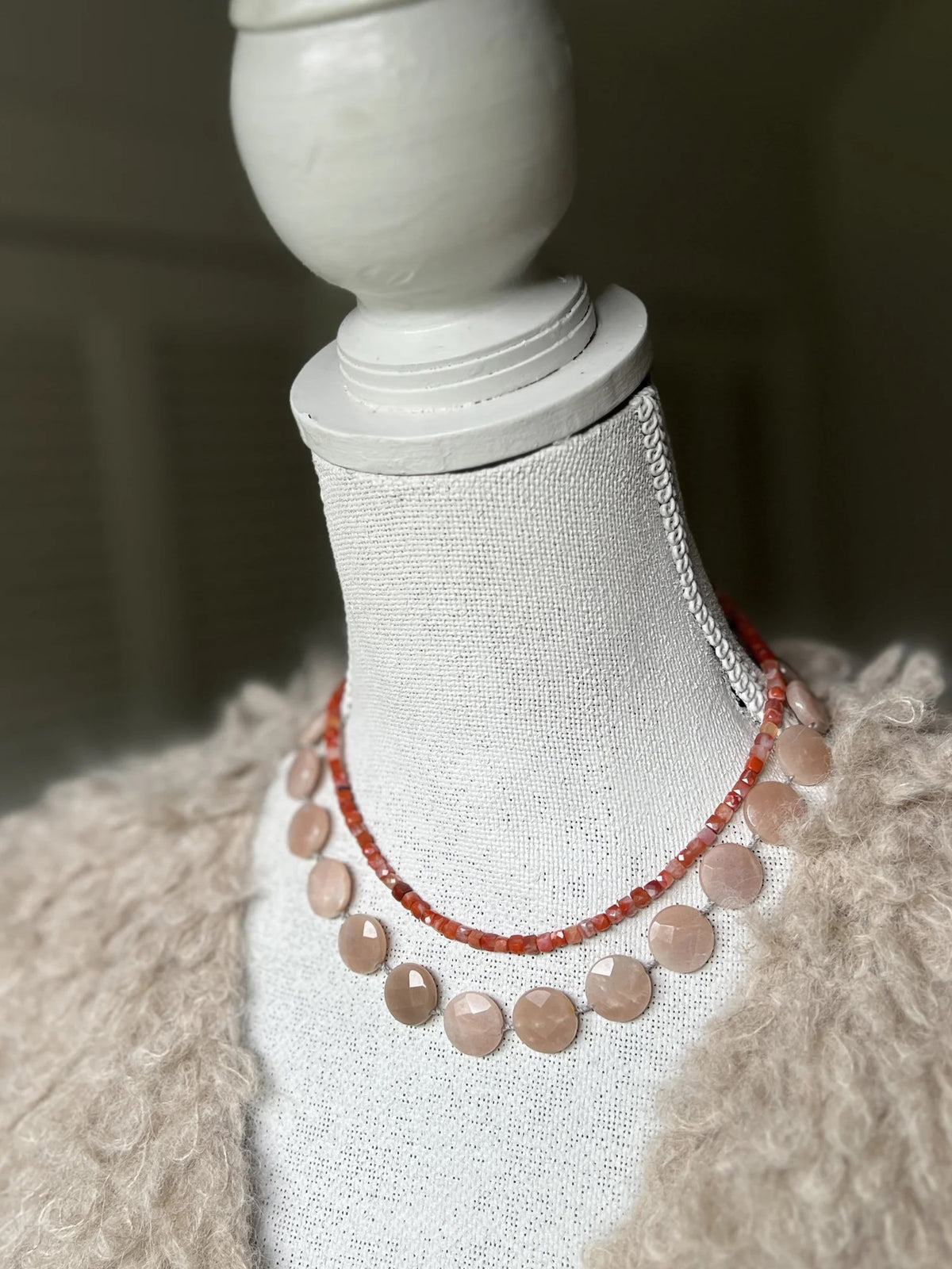 The ANN LIGHTFOOT Cube Carnelian Ras Du Cou Necklace features small, square red and pink beads in a single loop with a sterling silver clasp, shown on a white background.