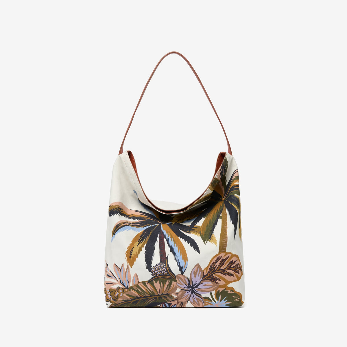 The INOUI EDITIONS - HAWAII CAMPUS CANVAS BAG highlights a tropical landscape in earthy tones with palm trees and foliage, offering a painterly vintage charm. Its slouchy design and single leather strap elegantly combine style and function against a plain white background.
