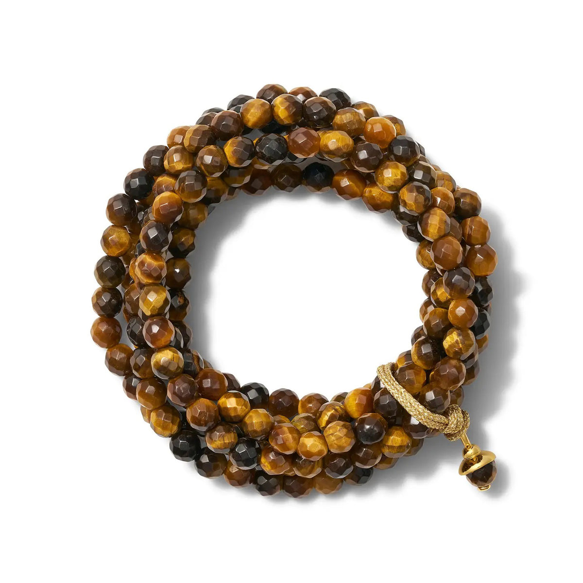 The Sally Bracelet in Tiger Eye by CC &amp; Co by Catherine Canino features stunning faceted tiger's eye beads in rich brown and golden yellow, a decorative gold clasp, and a charm on textured gold thread for an elegant touch.